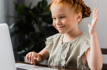 Girl waving at webcam
